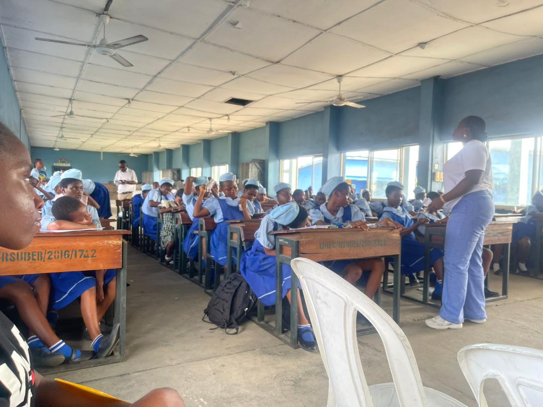 Amen Rachael engaging with students during outreach